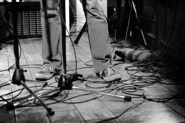 Musician feet at Trees cafe Vancouver. Black and white.